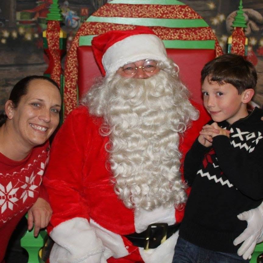 Ian as a young boy with his mom, posing with Santa