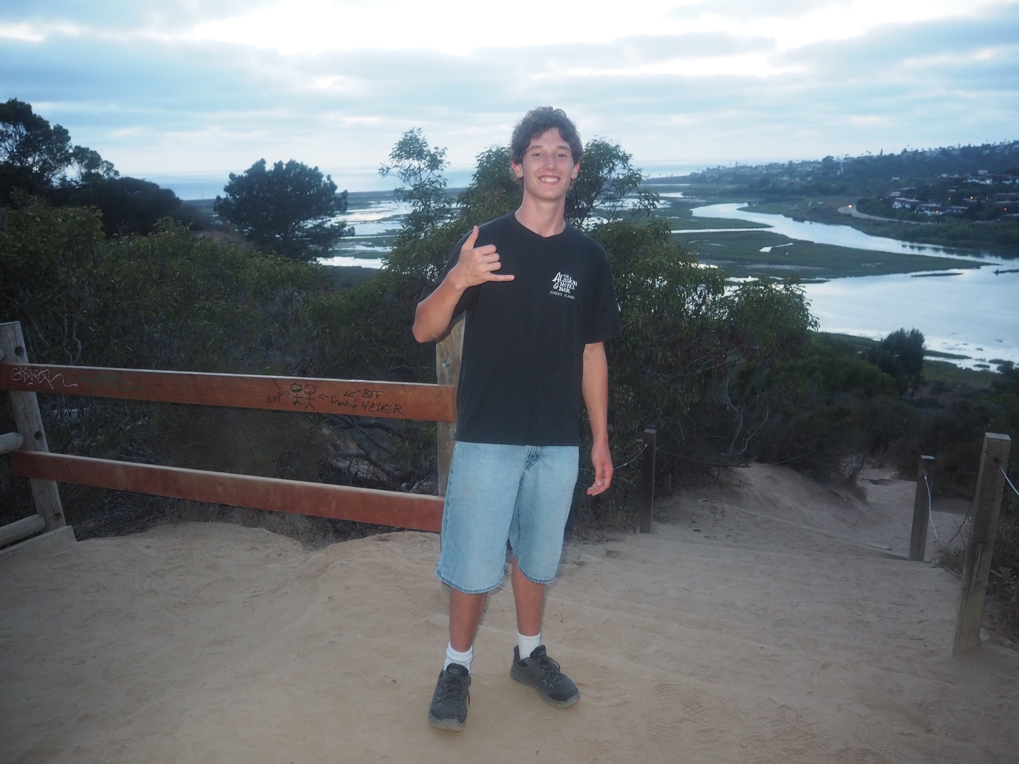 Ian on a coastal trail overlooking a lagoon