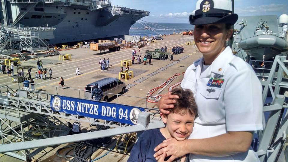 Ian with his mom in Navy dress whites on the pier beside USS Nitze (DDG 94)